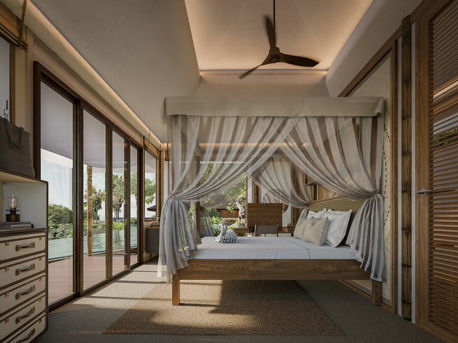 Tented suite bedroom with canopy bed and pool view